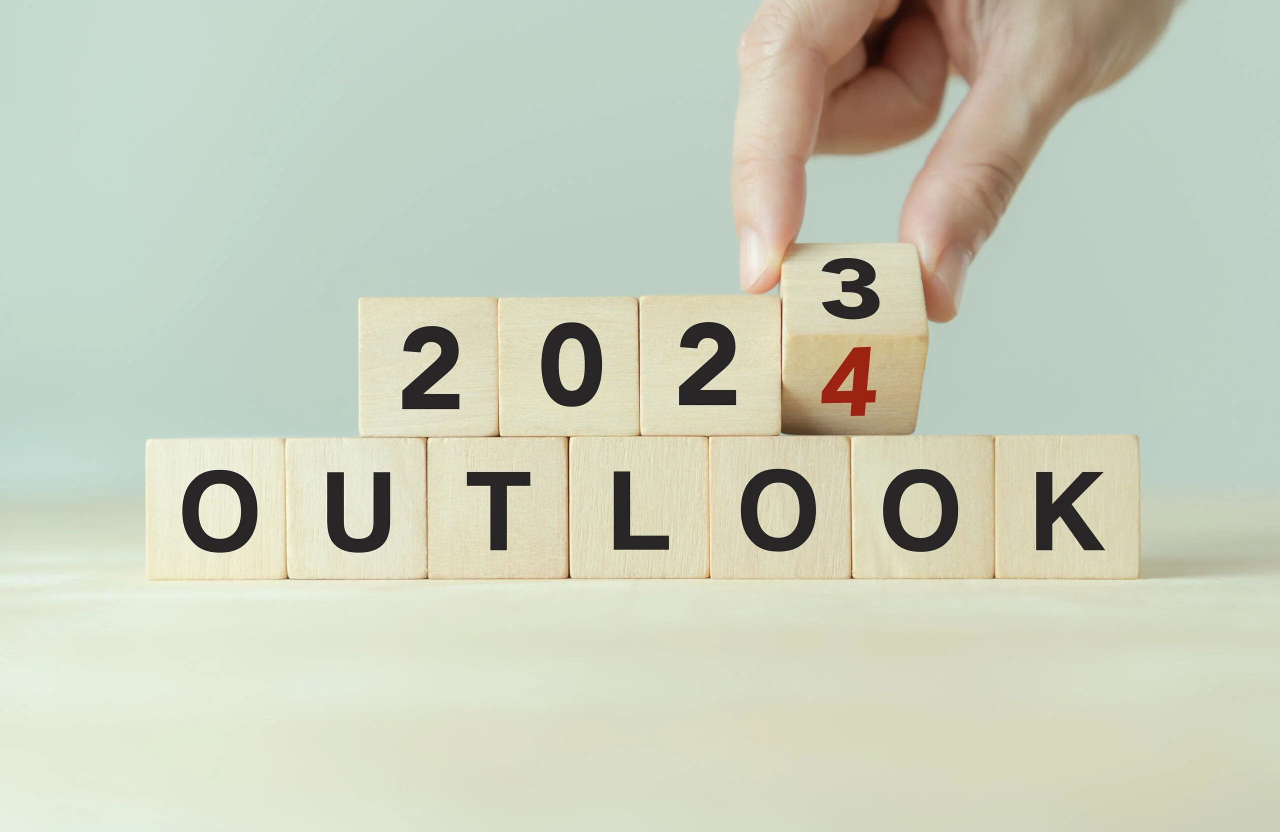 Economic outlook concept Financial business review or economic growth forecast for 2024 Turning OUTLOOK 2023 to 2024 text on wooden cube blocks